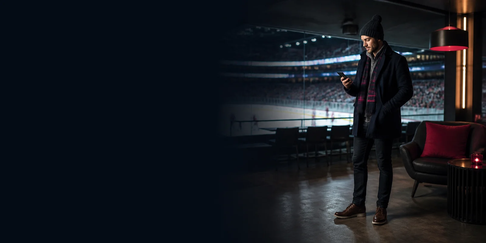 Canadian sports fan using a mobile casino in an arena lounge